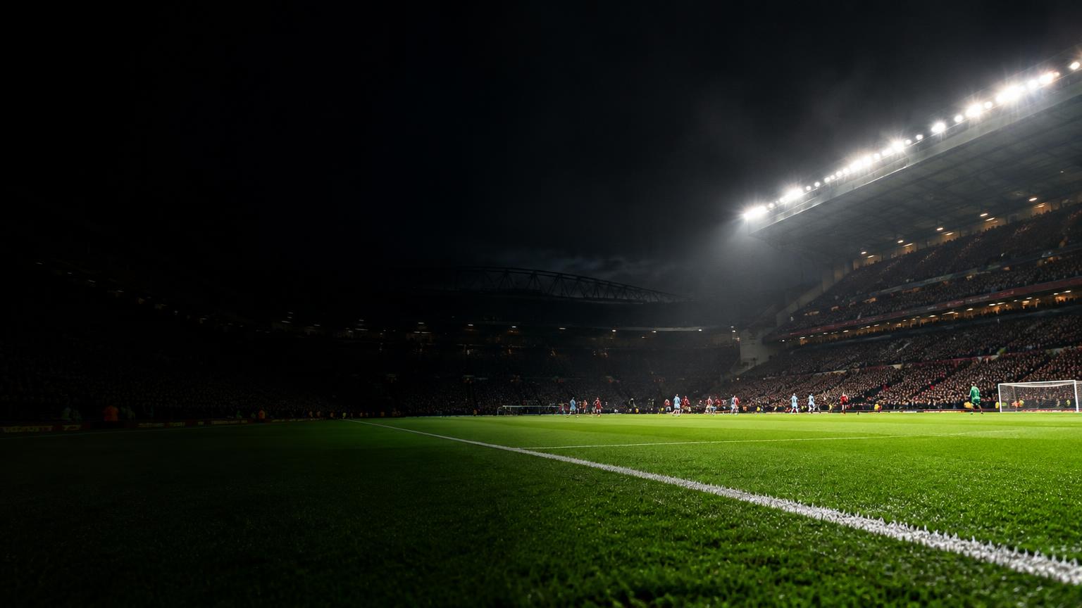 Floodlights illuminating a football pitch on match night